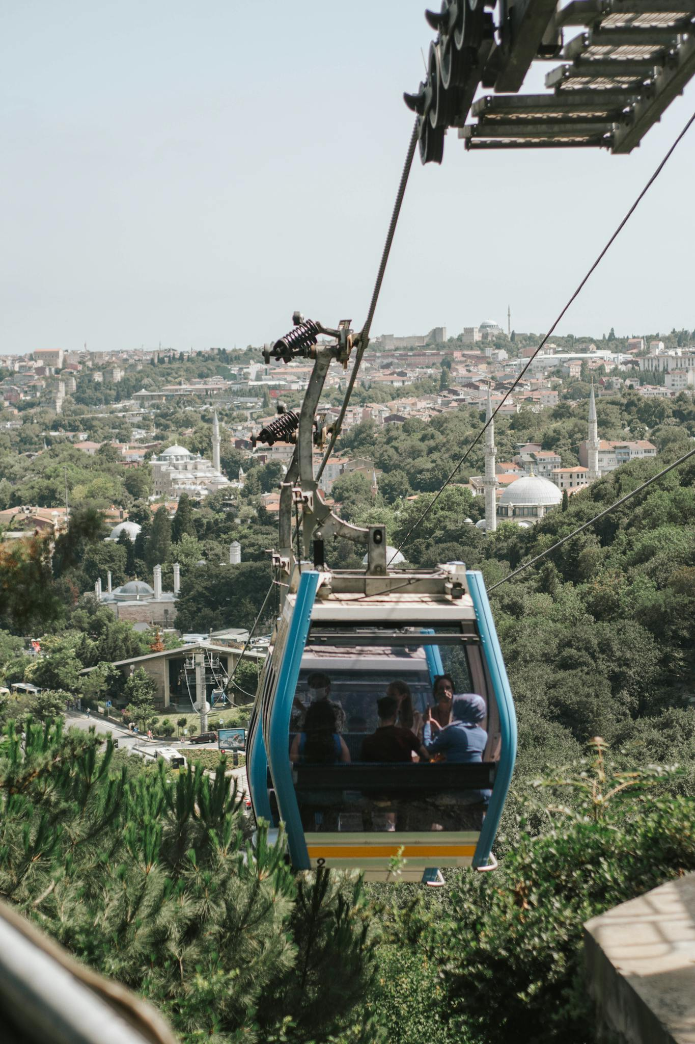 Enjoy a breathtaking view from a cable car over a lush cityscape filled with iconic landmarks.